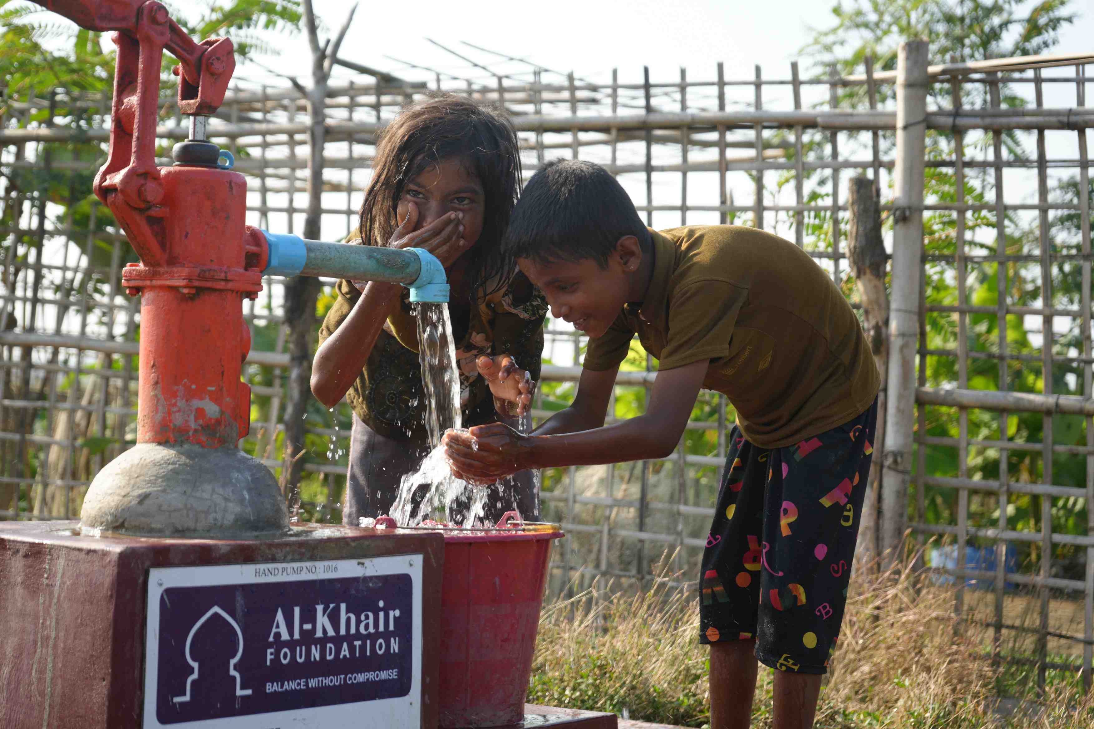 water well, children drinking from water well
